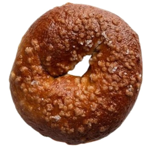 A single Ugly Bagel, dark brown and textured with visible salt crystals, against a white background.