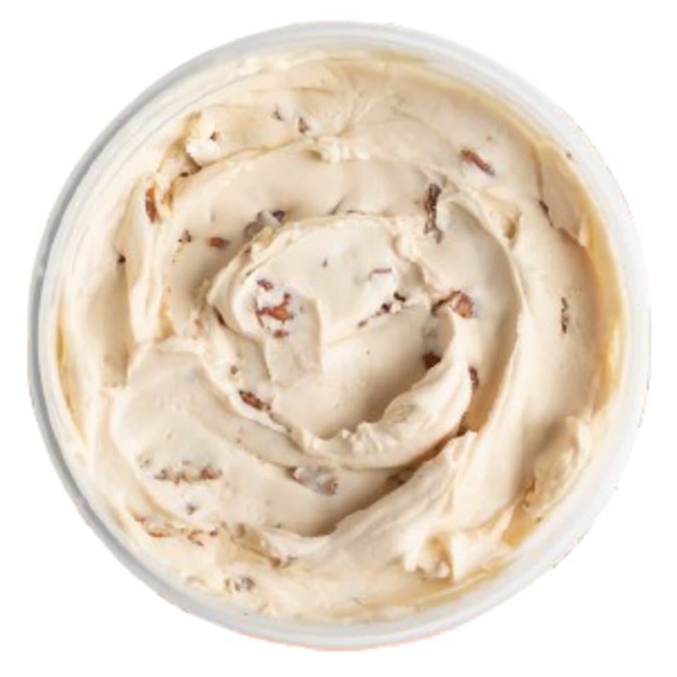 Overhead view of a container filled with creamy, light brown Ugly Bagel cinnamon cream cheese.