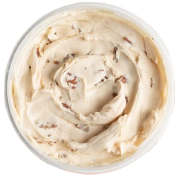 Overhead view of a container filled with creamy, light brown Ugly Bagel cinnamon cream cheese spread.