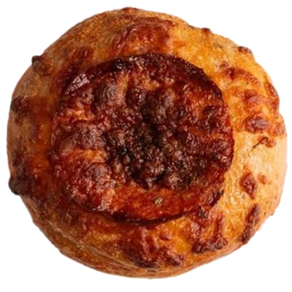 Top-down view of a round, golden-brown Ugly Bagel with a dark, crispy cheese topping.