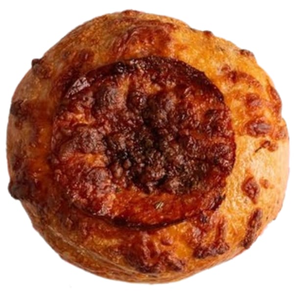 Top-down view of a round, golden-brown Ugly Bagel with a dark, crispy cheese topping.