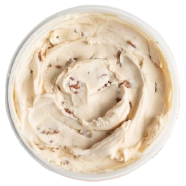 Overhead view of a container of Ugly Bagel's cinnamon cream cheese spread with visible spice flecks.